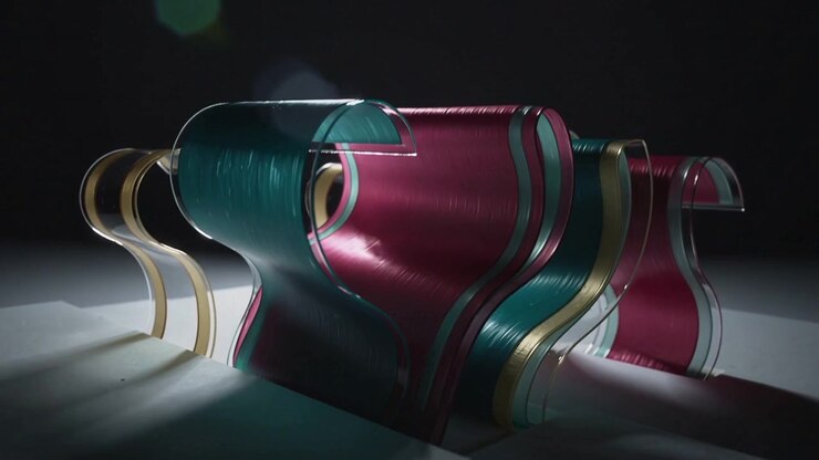 Starting slow right pan, camera revealing teal magenta gold ribbons on studio set, showing depth