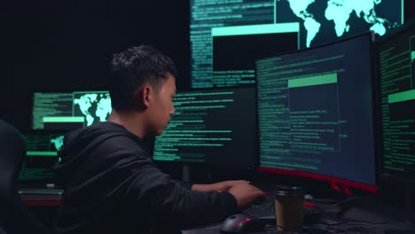 asian boy hacker hacking with multiple computer screens and pose in dark room