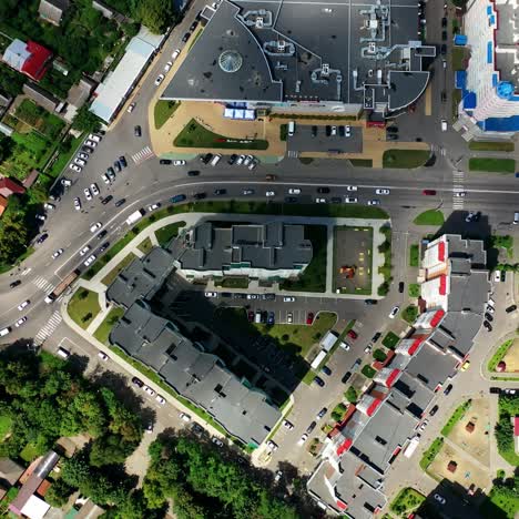 rooftops of modern residential buildings. panoramic view of a cityscape with buildings and moving cars on road. top down view.