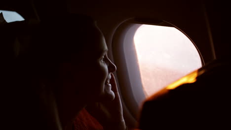 woman talking on the phone in plane