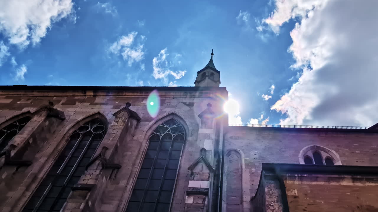 Sun flares behind former Minorite Church of St. Salvator in Regensburg
