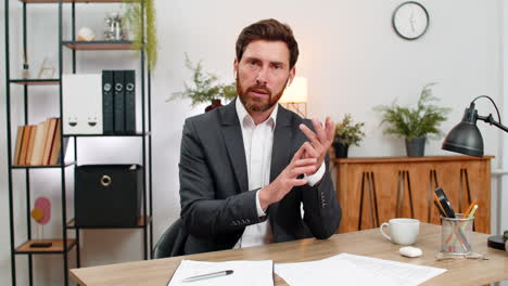 middleaged businessman consultant presents on camera smiles and speaks during video conference live