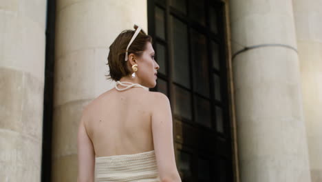 rear view of elegant woman with sunglases on her head