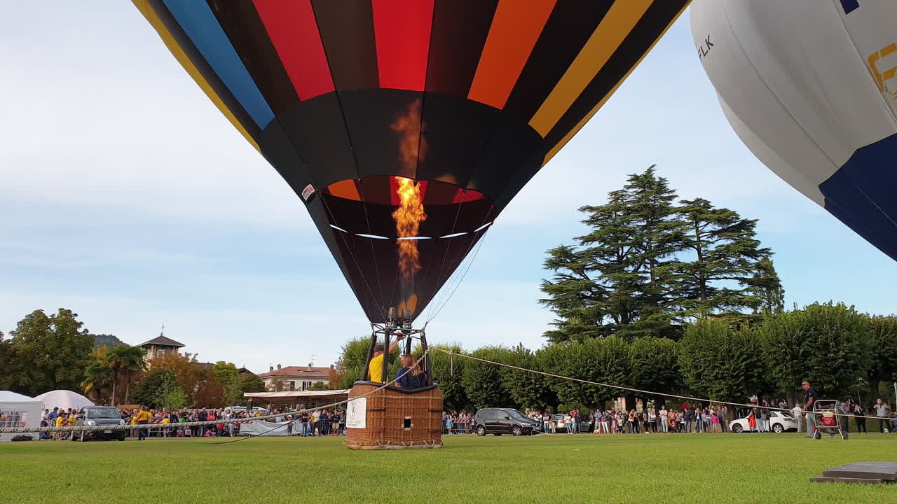 people watching about to launch hot air balloon, still low angle shot