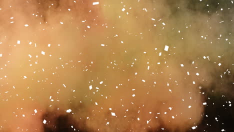 animation of white confetti, yellow and orange powder falling, on black background