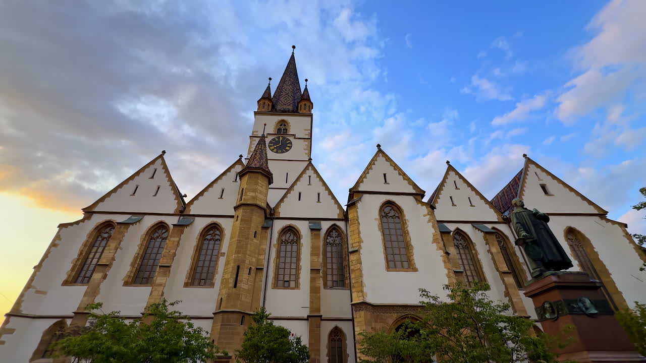 Gothic Cathedral view in Sibiu. Wide view of the Gothic Lutheran Cathedral in Sibiu with blue sky and evening light