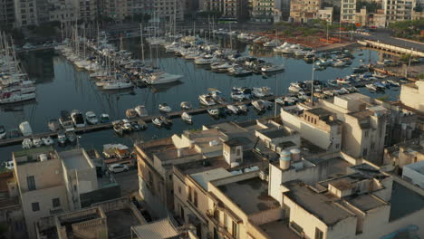 Small-Mediterranean-Town-on-Malta-Island-view-on-Harbour-with-Yachts-and-Sailboats