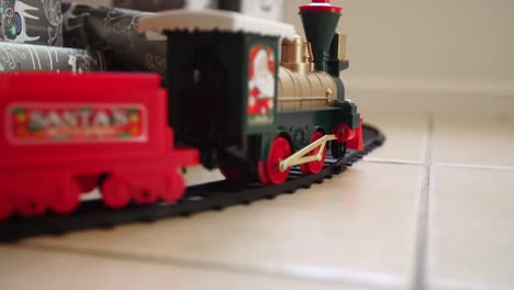 toy train moving past christmas presents, slow motion