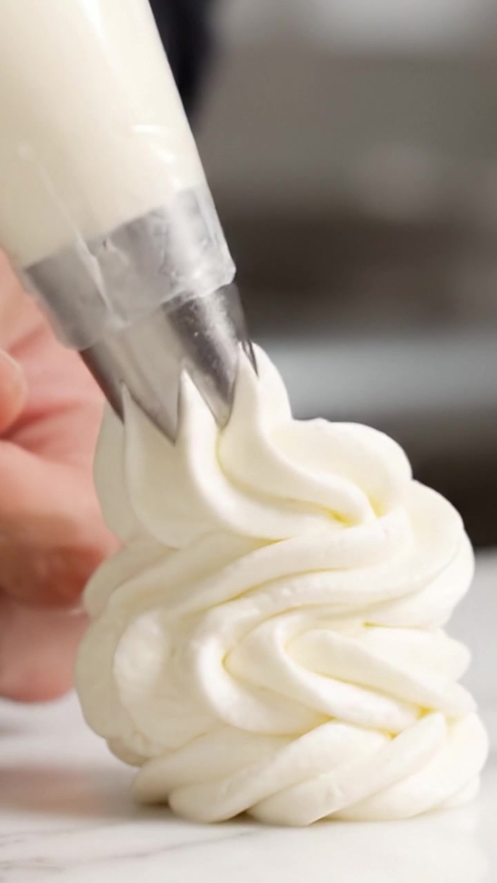 Expertly Piped Cream: A Step in the Art of Pastry where Cream is Passionately Crafted into Stunning Decorative Shapes for Culinary Excellence