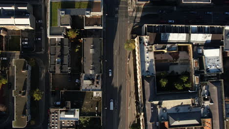 top down aerial view, street traffic in neighborhood of dublin, ireland on sunny evening, high angle drone shot