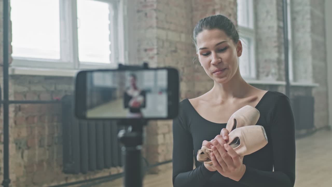 Female Ballet Teacher Recording Video On Smartphone