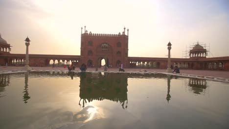 tracking shot past people cleaning at temple