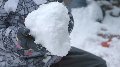 child making a snowball