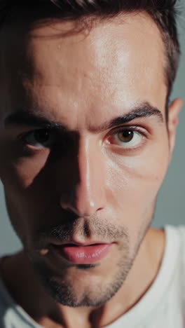 close-up portrait of a man with intense gaze and stubble