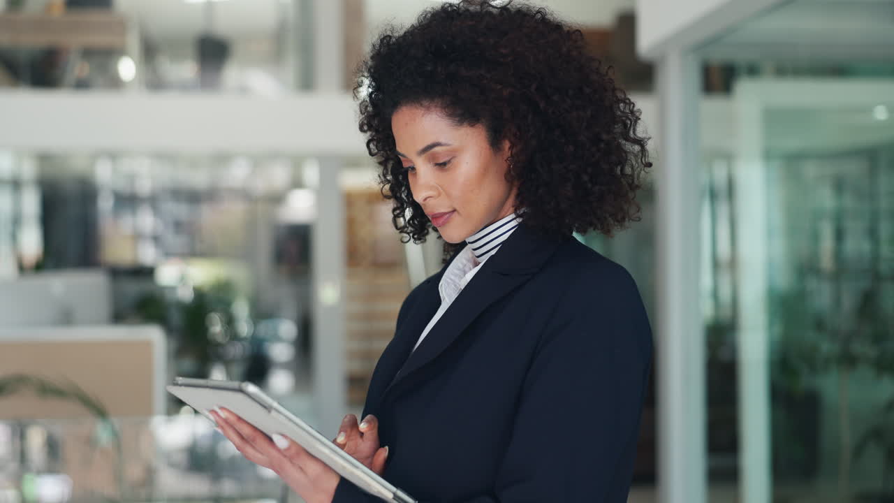 Professional businesswoman using a tablet in a modern office