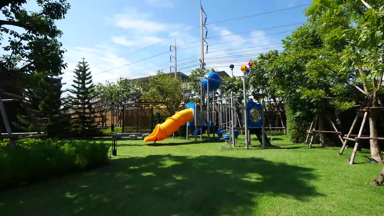 Colorful Children Playground In The Garden On Sunny Day