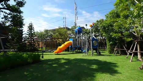Colorful-Children-Playground-In-The-Garden-On-Sunny-Day