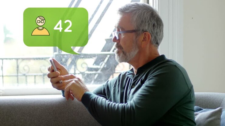 Man sitting on a couch while typing on his phone 4k
