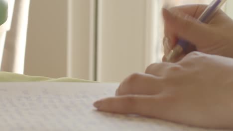 Gorgeous-shot-of-woman-writing-in-notebook-or-journal