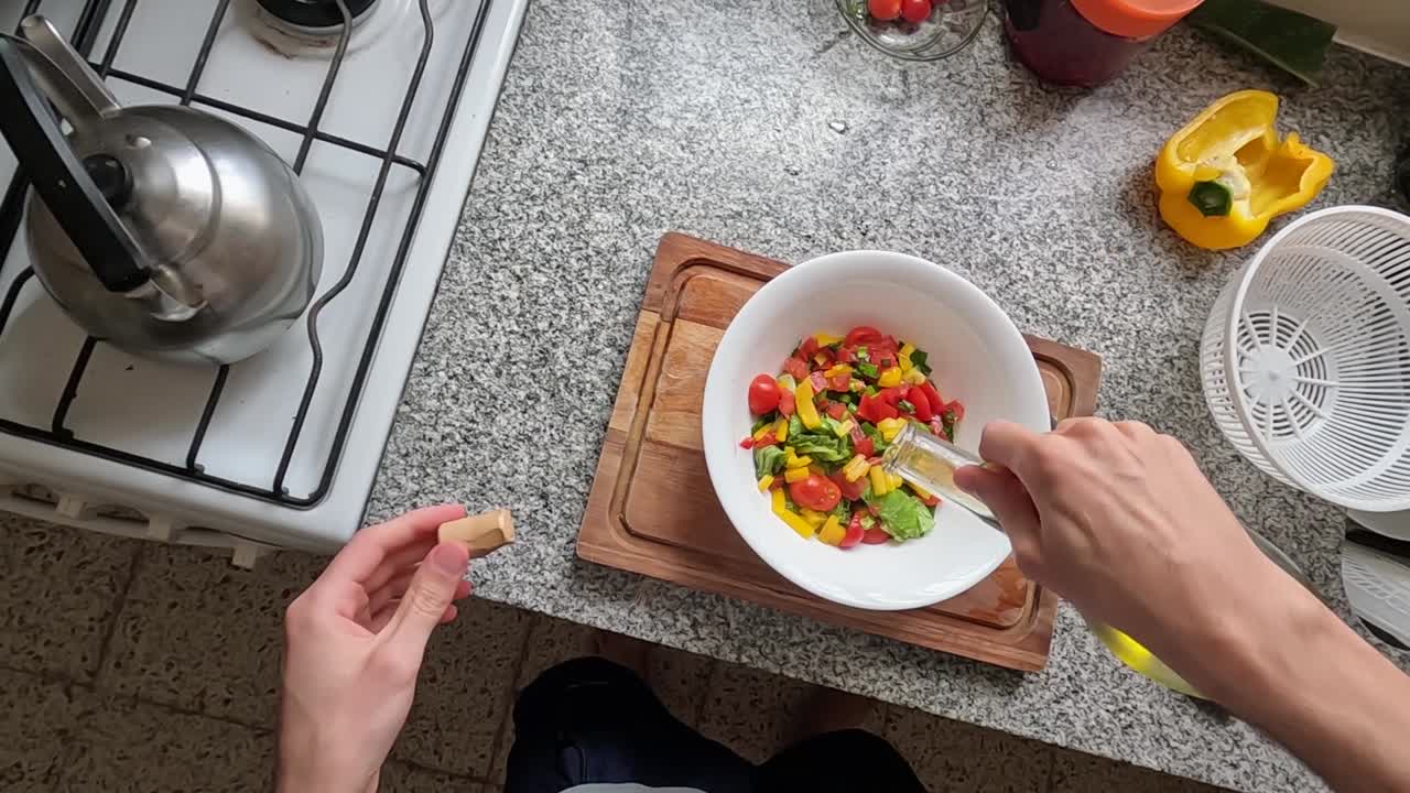 부엌에서 샐러드에 올리브 오일을 추가하는 요리사 pov