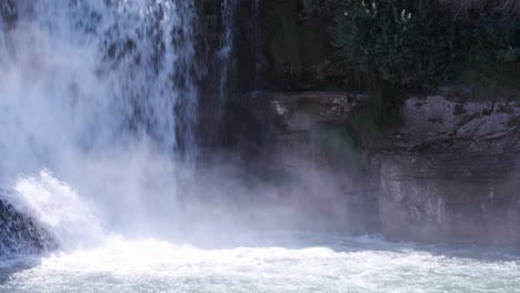 mist rises up vertical wall at base of powerful lundbreck waterfall