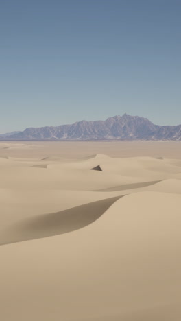 sand dunes and a mountain range in the desert