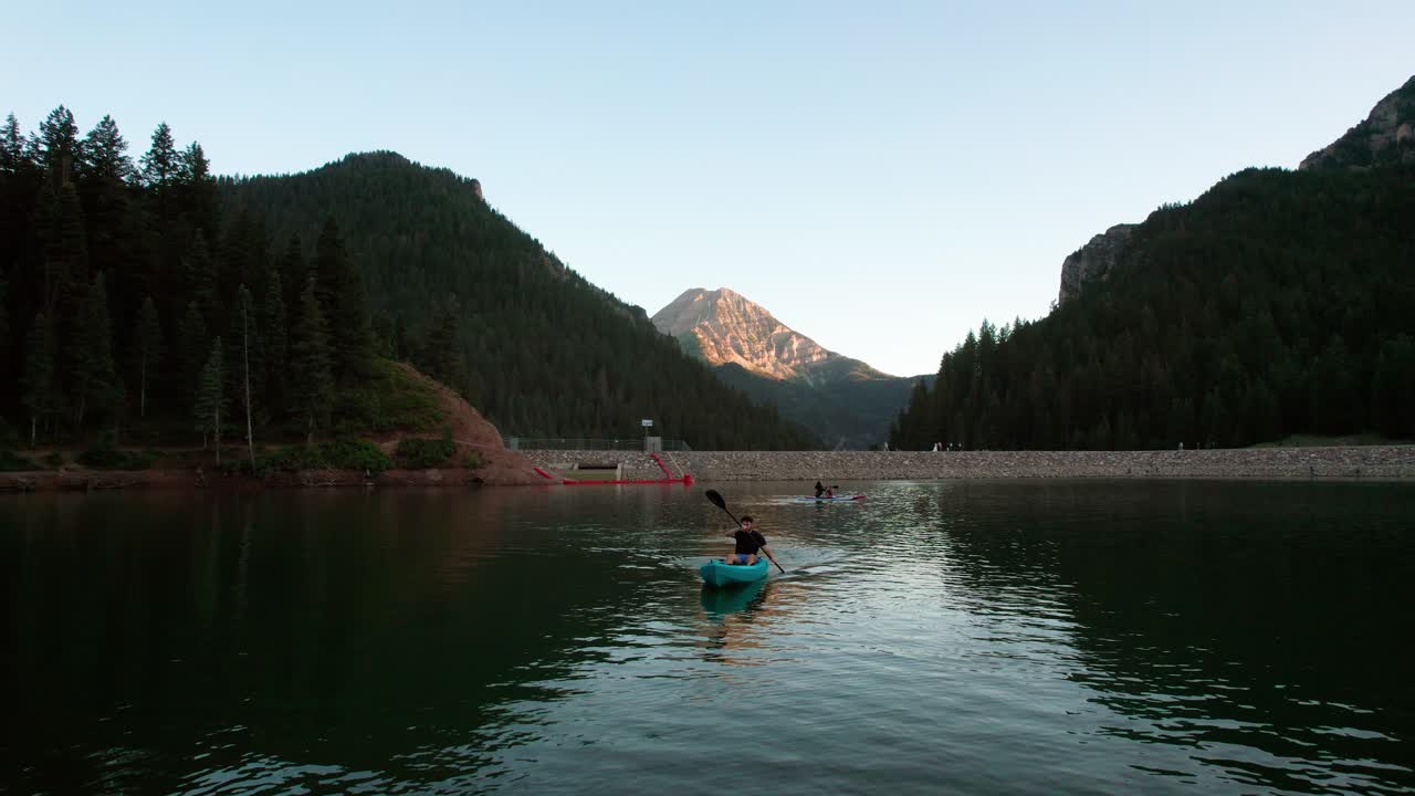 Man Kayaking in Utah Mountain Lake at Sunset, Scenic Aerial Video