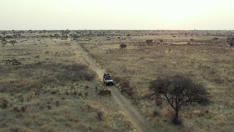 people on off-road car driving along safari trails in namibia, africa