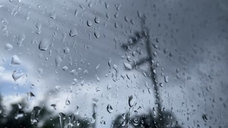 rainy fall autumn season, looking out window, depressing water drops, grey sky