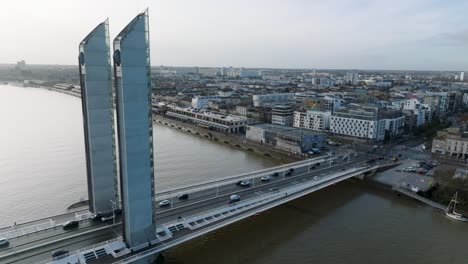 jacques chaban delmas bridge over the garonne river in bordeaux france with car traffic, aerial pan right shot