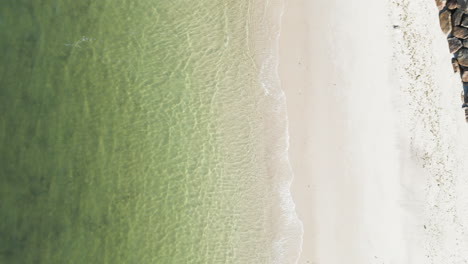 the clear green water and white sandy beach in dennis port, nantucket sound, ma, aerial view