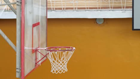 basketball ball flies into the basket in the old sports hall.