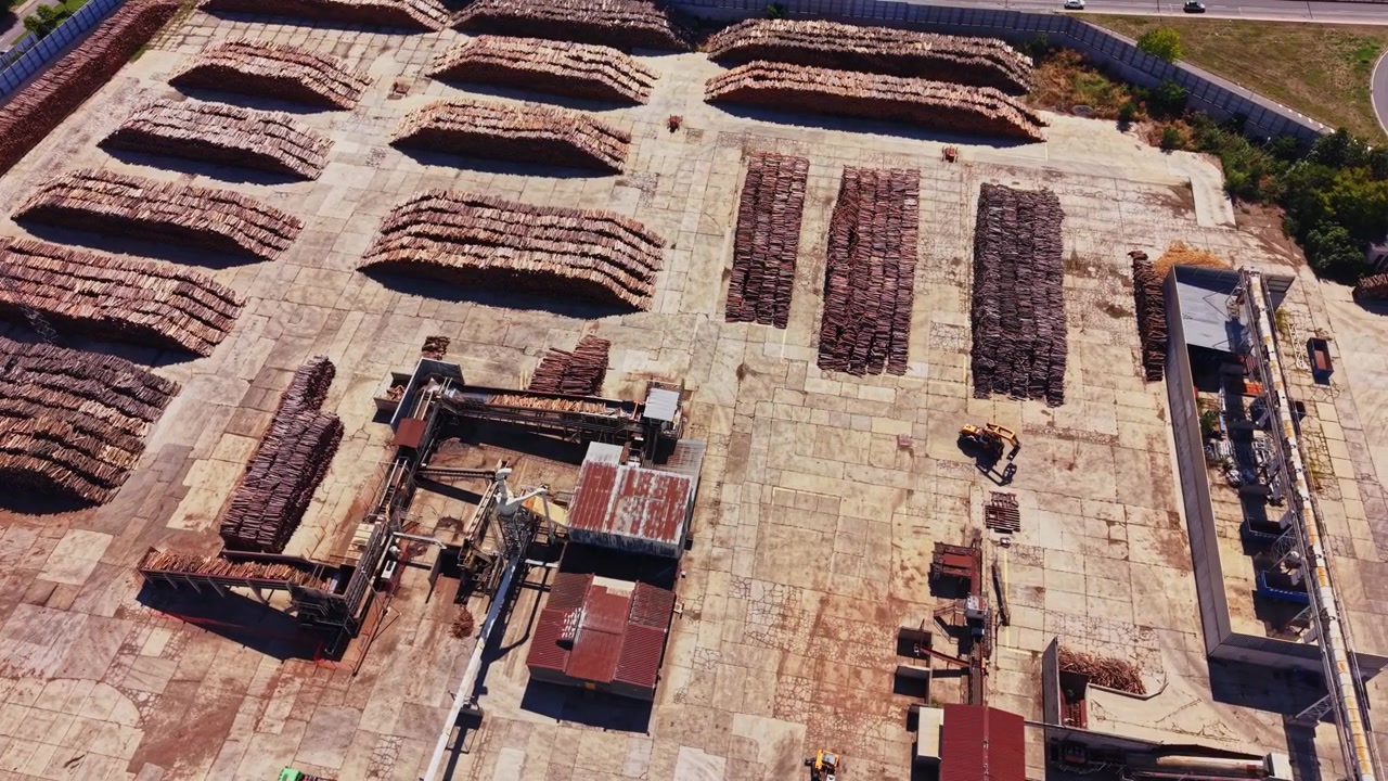 Wood storage area showing stacks of timber and equipment