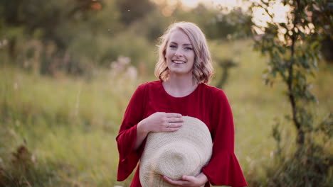 beautiful woman posing into camera and smile at golden sunset