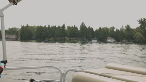 Green-Forest-At-The-Waterfront-Of-The-Lake-From-The-View-On-The-Sailboat