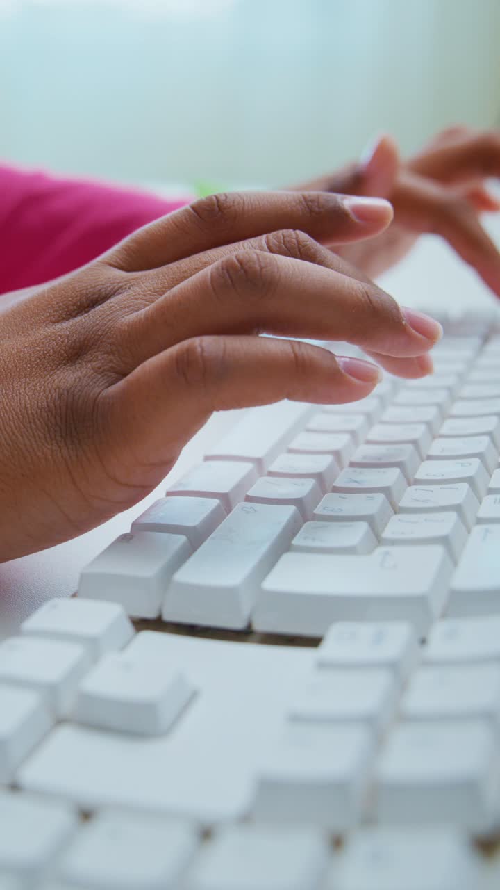 Close-up of Hands Typing on a White Computer Keyboard