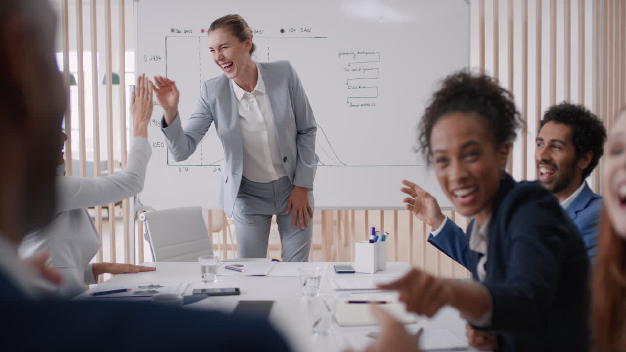 happy business people celebrating success in boardroom meeting enjoying corporate victory colleagues high five in office presentation