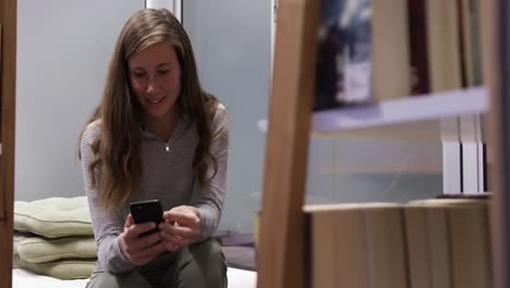 Creative-businesswoman-using-smartphone-in-modern-office