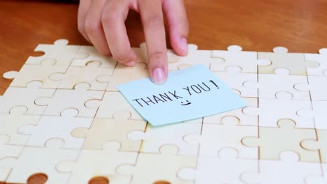 a heartfelt thank you note placed a jigsaw puzzle symbolizes appreciation and connection