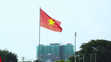 a vietnamese flag behind the blue sky long shot