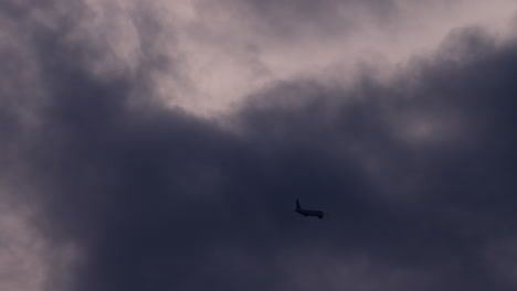 airplane flying through dark stormy clouds