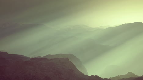 Majestic mountain landscape with gentle light rays in morning mist