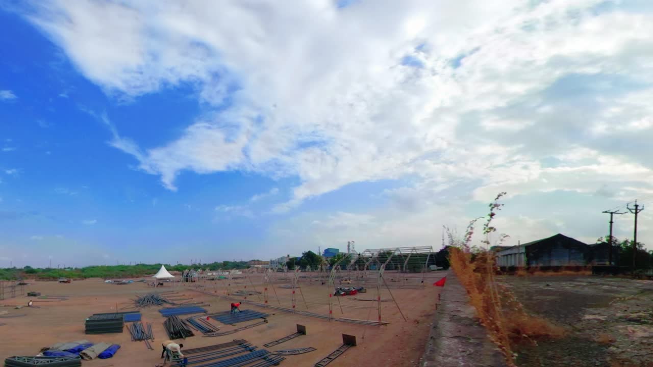 Different parts of metal scaffold on the construction field, Workers build an industrial doom, worker build a concert stage, stage equipment, timelapse of Hugh contraction on-site