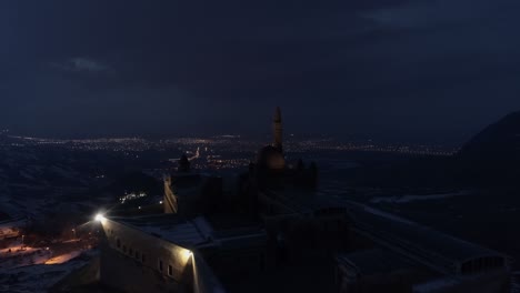 aerial night view of ishak pasha palace in agri. 4k footage in turkey