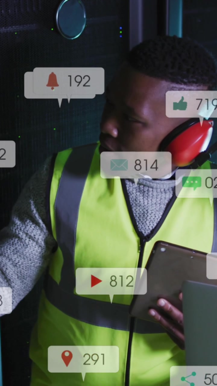 Animation of social media icons on african american male and female engineers working at server room