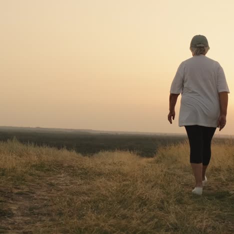 An-Elderly-Woman-Goes-Towards-The-Sunset