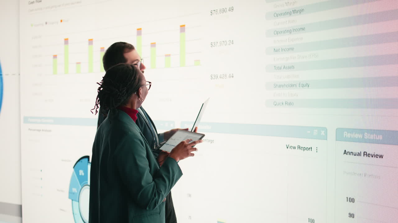 Business Professionals Analyzing Financial Data on Large Digital Screen