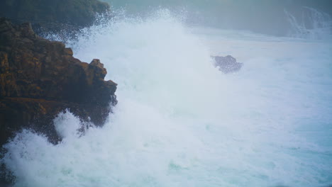 powerful waves breaking cliff making explosion. closeup dramatic ocean washing