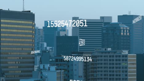 animation of changing numbers over aerial view of modern buildings in background