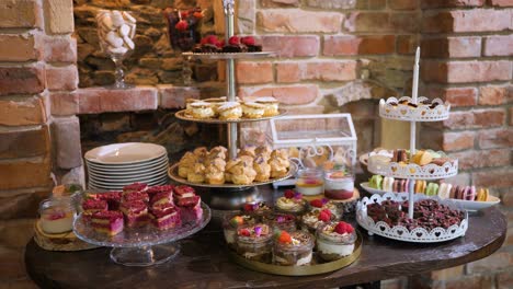 beautifully decorated catering table with cakes in restaurant or hotel